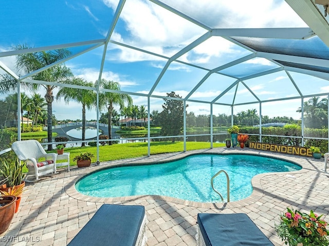 view of swimming pool featuring glass enclosure, a water view, and a patio area