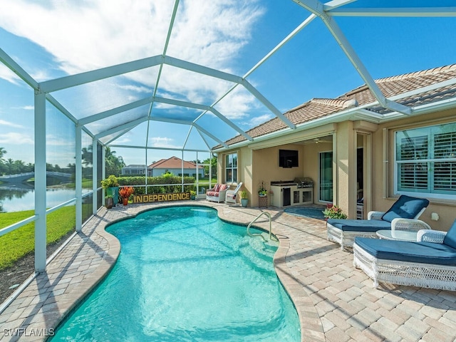 view of swimming pool with ceiling fan, a water view, a patio, and a lanai