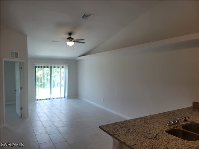 unfurnished room with light tile patterned floors, sink, ceiling fan, and high vaulted ceiling