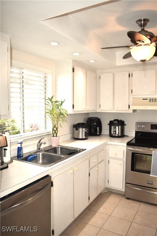 kitchen featuring sink, ventilation hood, stainless steel appliances, light tile patterned floors, and ceiling fan