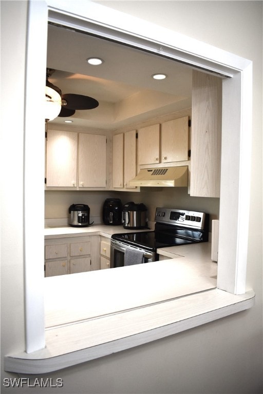 kitchen with light brown cabinetry and electric range