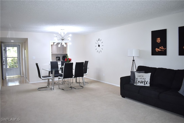 carpeted living room featuring a textured ceiling and a chandelier