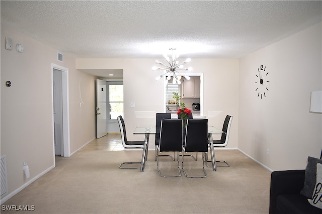 dining space with light carpet, a textured ceiling, and a chandelier