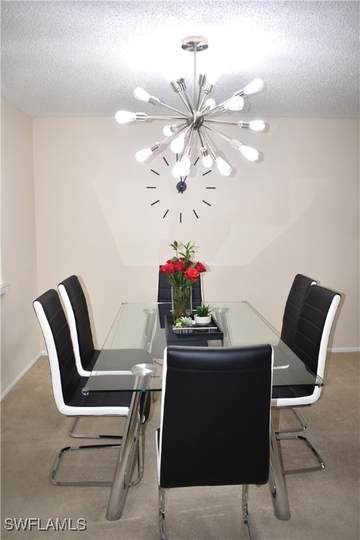 dining space featuring a textured ceiling, a notable chandelier, and carpet