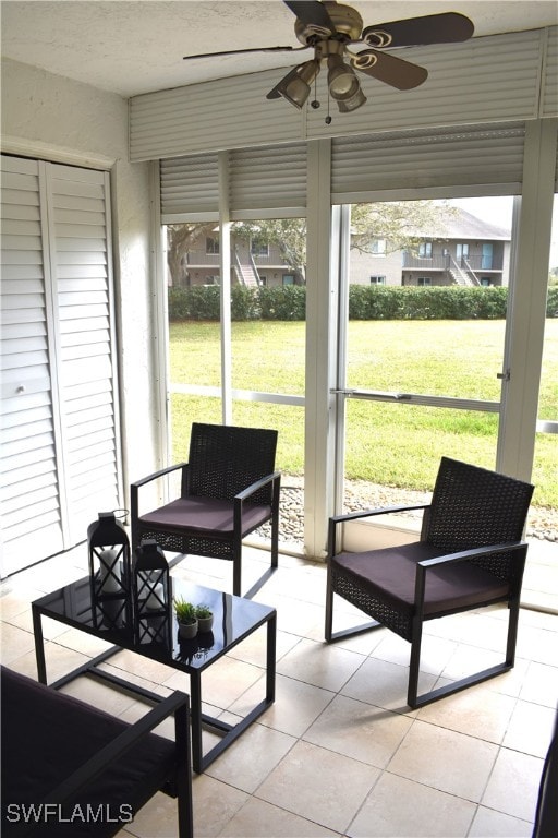 sunroom / solarium featuring ceiling fan and a healthy amount of sunlight