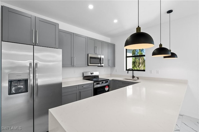 kitchen with gray cabinetry, sink, decorative light fixtures, and appliances with stainless steel finishes