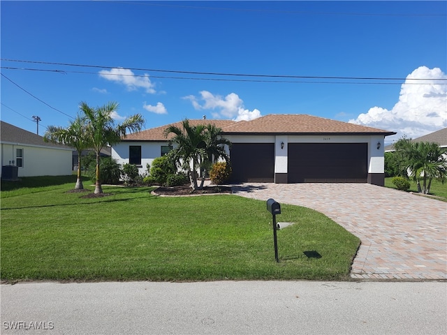 single story home featuring a garage and a front lawn