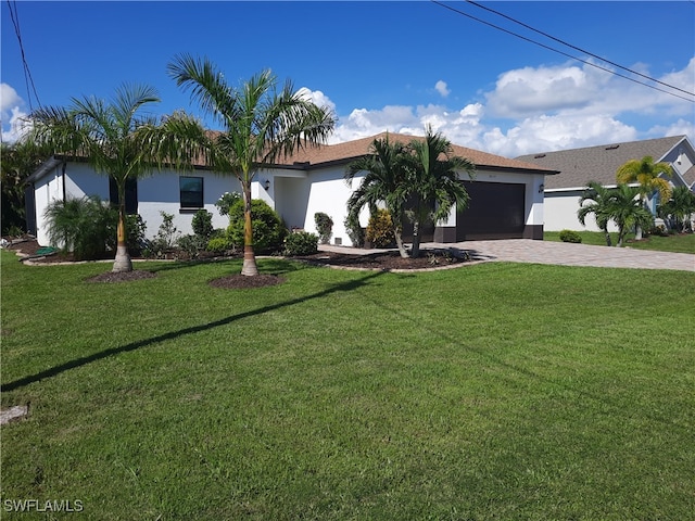 view of front of house with a garage and a front yard