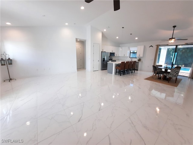 living room featuring ceiling fan and lofted ceiling