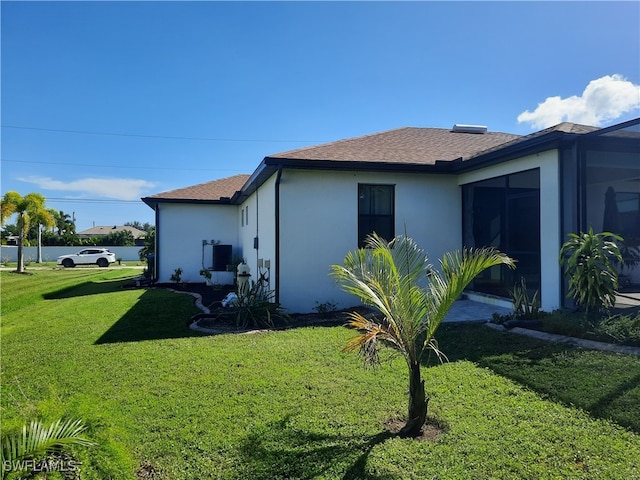 view of property exterior featuring a yard and central air condition unit