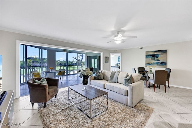 tiled living room with ornamental molding, a water view, and ceiling fan