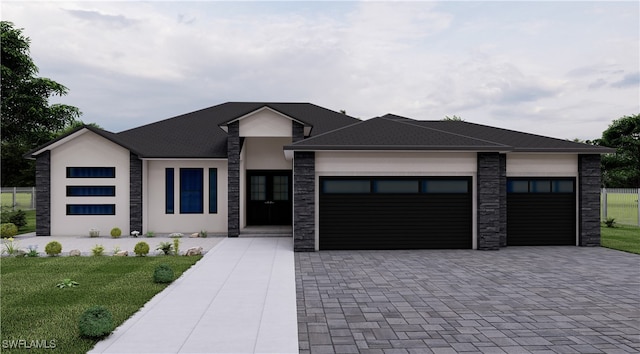 prairie-style home with a front lawn and a garage