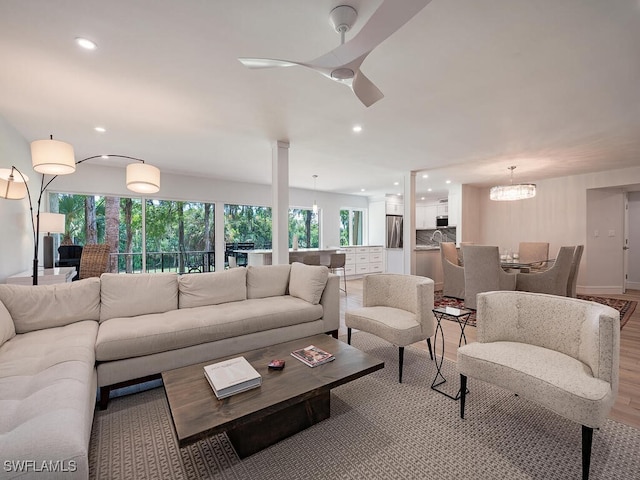 living room featuring an inviting chandelier and light hardwood / wood-style flooring