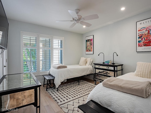 bedroom featuring light wood-type flooring and ceiling fan