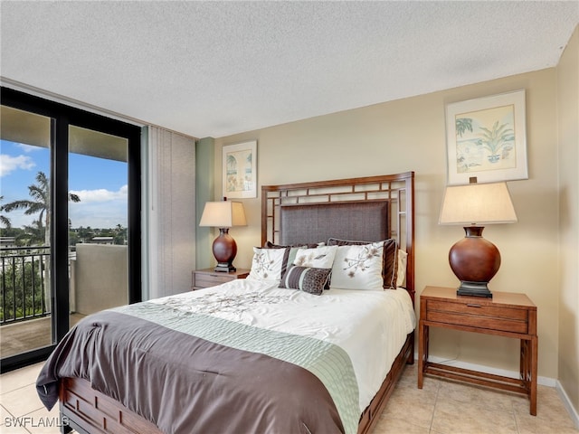 bedroom with access to exterior, light tile patterned flooring, and a textured ceiling