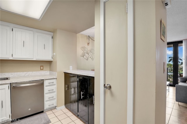 kitchen featuring dishwasher, white cabinetry, and light tile patterned floors