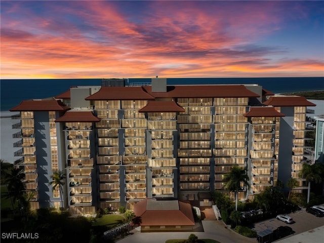 outdoor building at dusk featuring a water view