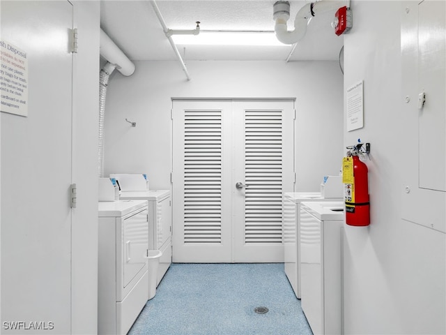 washroom with washing machine and dryer