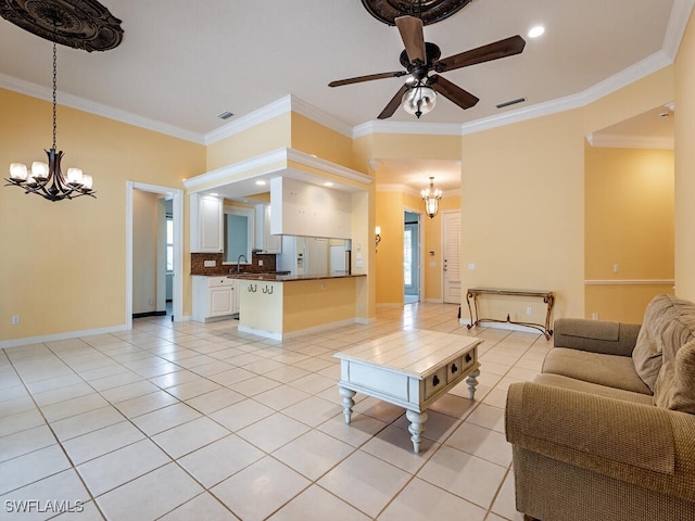 living room with crown molding, ceiling fan with notable chandelier, and sink