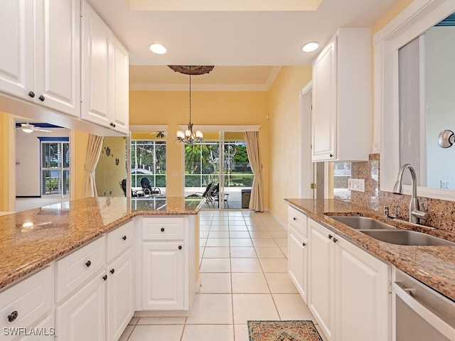 kitchen featuring white cabinetry, ceiling fan with notable chandelier, dishwasher, pendant lighting, and sink