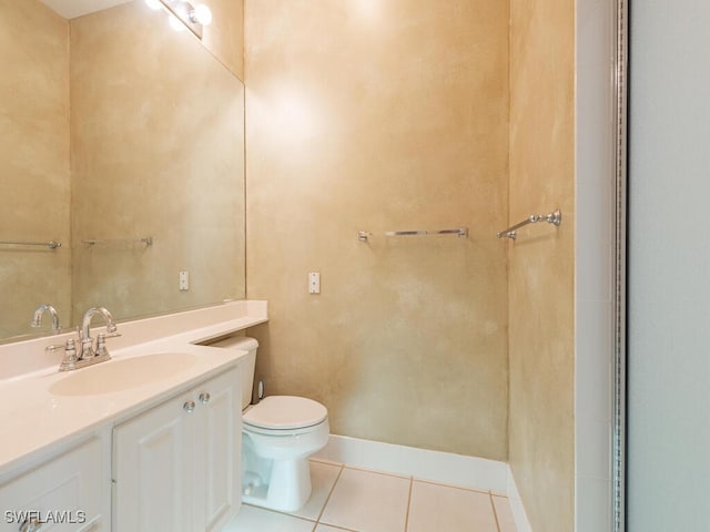 bathroom featuring tile patterned floors, vanity, and toilet