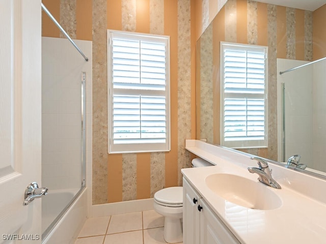 full bathroom featuring vanity, tile patterned floors, toilet, and a healthy amount of sunlight