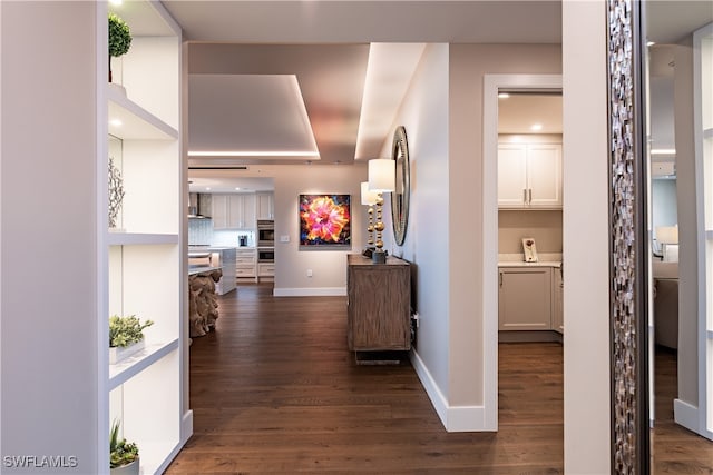 corridor with dark hardwood / wood-style floors