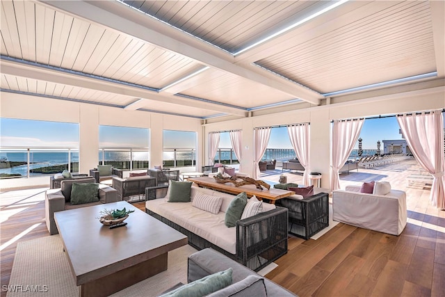 interior space featuring a wealth of natural light, a water view, wood ceiling, and hardwood / wood-style flooring