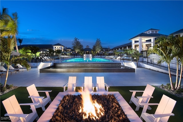 view of swimming pool with a patio and an outdoor fire pit