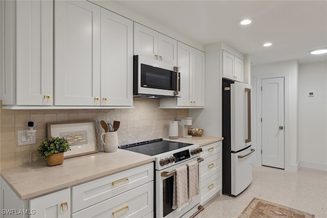 kitchen with white cabinets, high quality appliances, and decorative backsplash