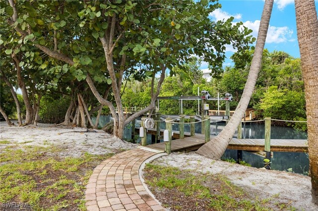 exterior space featuring a boat dock and a water view