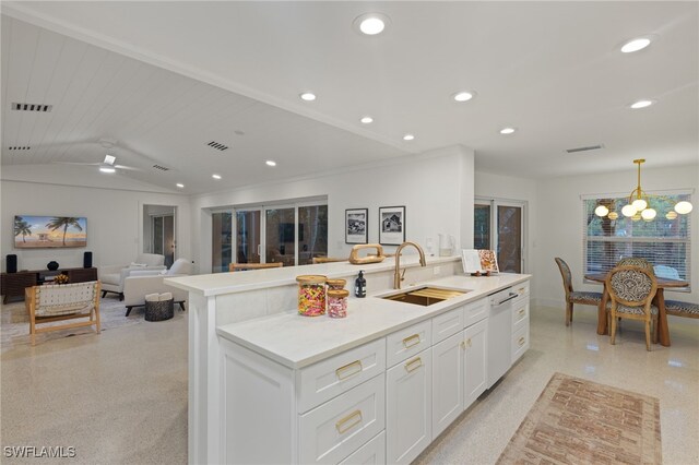 kitchen featuring sink, ceiling fan with notable chandelier, white cabinets, lofted ceiling, and white dishwasher