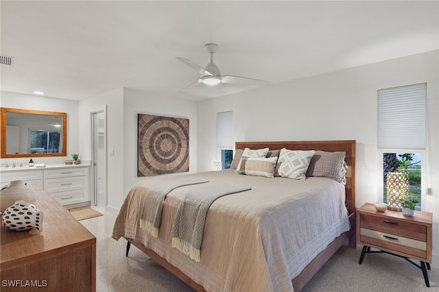 bedroom featuring light carpet, ceiling fan, and sink