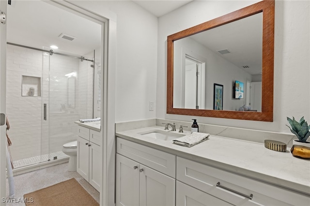 bathroom with walk in shower, vanity, and toilet