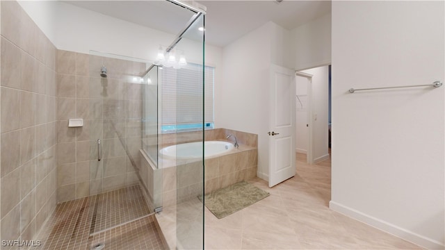 bathroom featuring tile patterned flooring and shower with separate bathtub