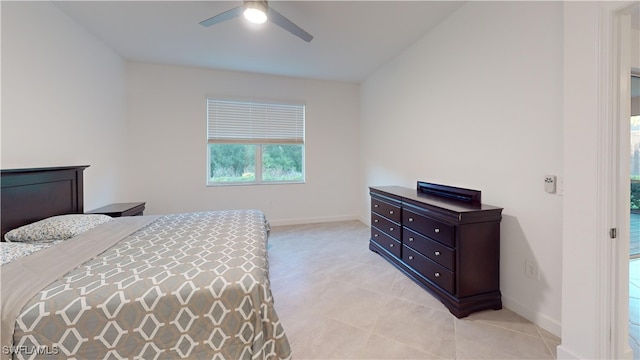 bedroom with ceiling fan, light tile patterned flooring, and lofted ceiling