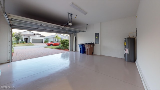 garage with electric panel, electric water heater, and a garage door opener