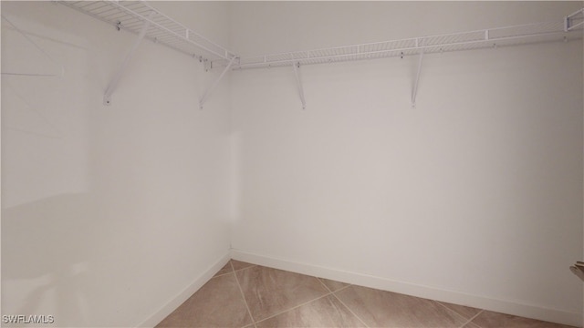 spacious closet featuring light tile patterned floors