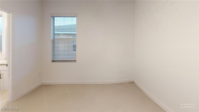 spare room with light tile patterned floors