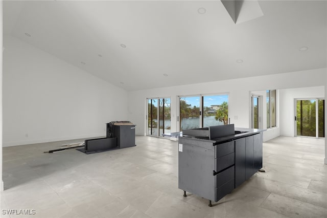 living room featuring a water view and high vaulted ceiling