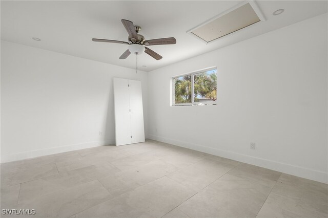 spare room featuring ceiling fan and light tile patterned flooring