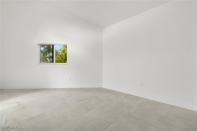 spare room with lofted ceiling