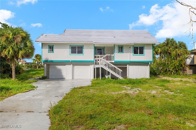 view of front of home with a garage and a front lawn