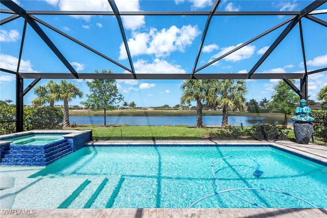 view of pool featuring glass enclosure, a water view, and an in ground hot tub