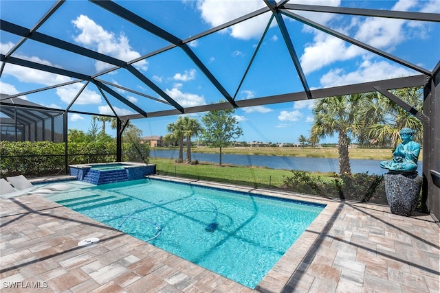 view of pool with glass enclosure, a water view, a patio, and an in ground hot tub