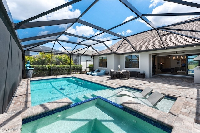 view of pool featuring a patio, an in ground hot tub, a lanai, and an outdoor hangout area