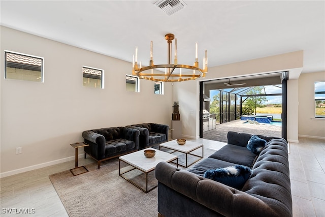 living room with light hardwood / wood-style flooring and a notable chandelier