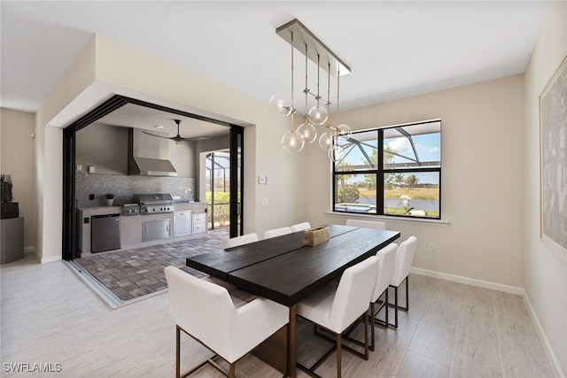 dining space featuring a healthy amount of sunlight, an inviting chandelier, and light hardwood / wood-style flooring