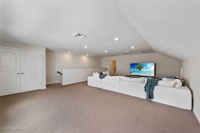 carpeted living room featuring vaulted ceiling