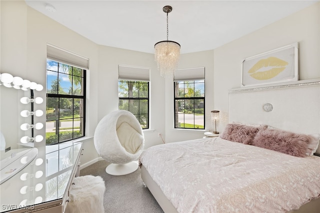 bedroom featuring carpet floors and a chandelier